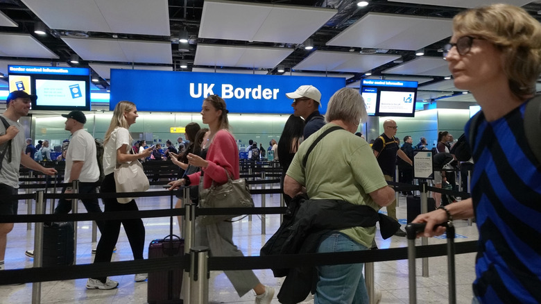 A line of people entering the airport's UK border.
