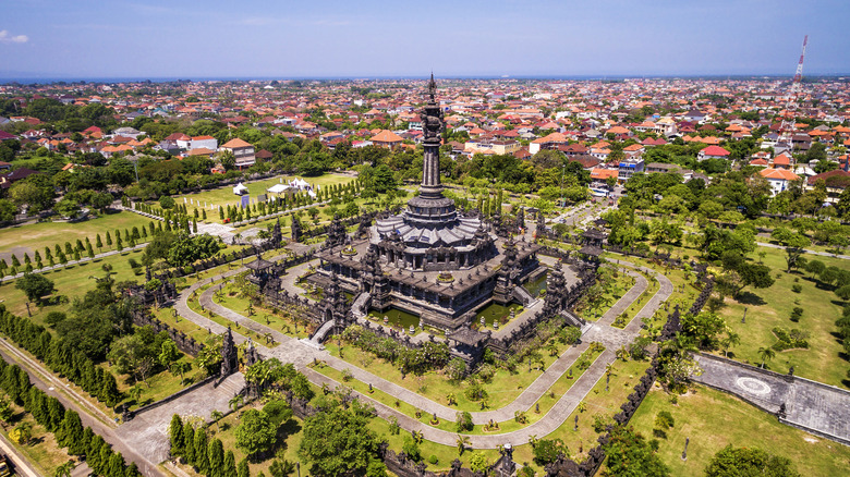Towering Indonesian monument surrounded by greenery in Denpasar