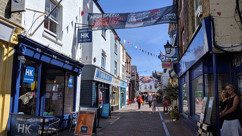 Lively brick street with shops and pedestrians in Cowes