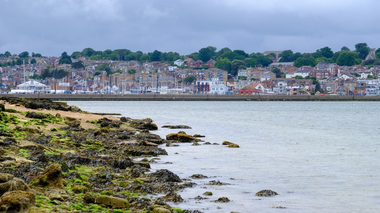 Coastal view of Cowes across water with rocky shoreline