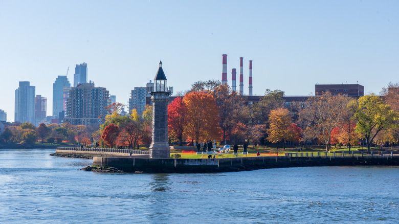 Roosevelt Island Lighthouse with autumn leaves behind it