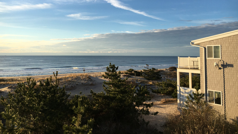 Sun rises over ocean, beach, and cottage home in Amagansett, New York