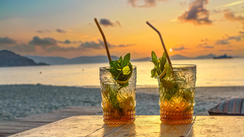 Cocktails on a table at the beach during sunset