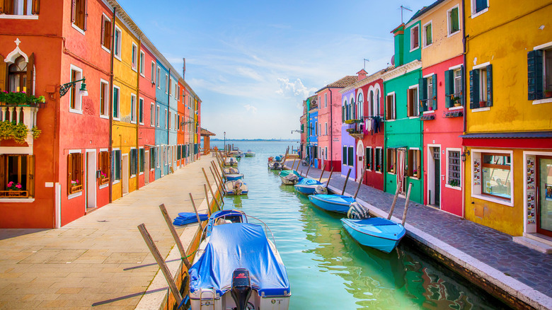 Colorful houses line a canal in Burano, Italy
