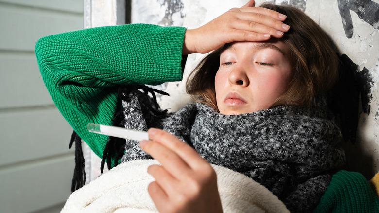 Woman looking at a thermometer