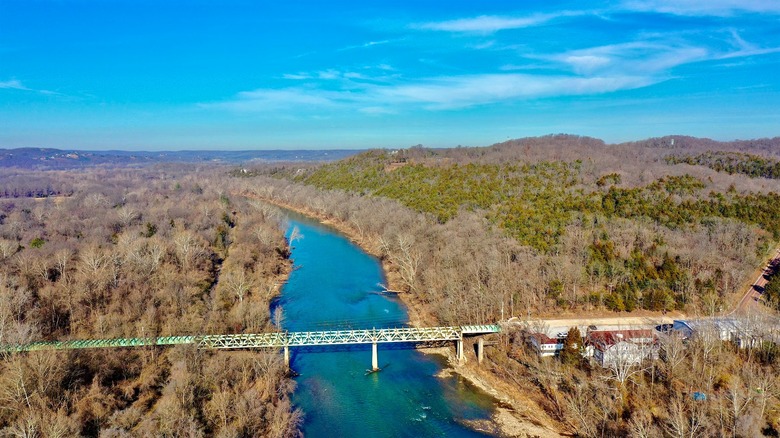 View of the river running through a forest, with a bridge cutting through it, Route 66 State Park in Eureka, Missouri