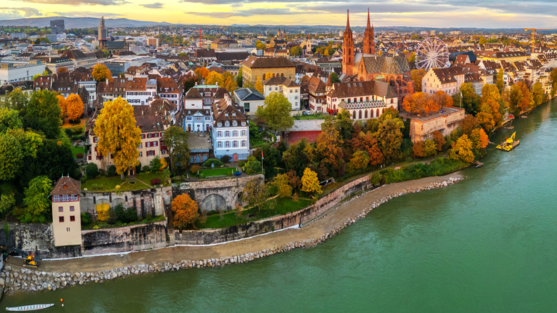 Beautiful historic buildings along the Rhine River in Basel at golden hour