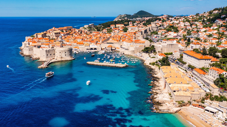 The walled city of Dubrovnik and the turquoise waters of its harbor