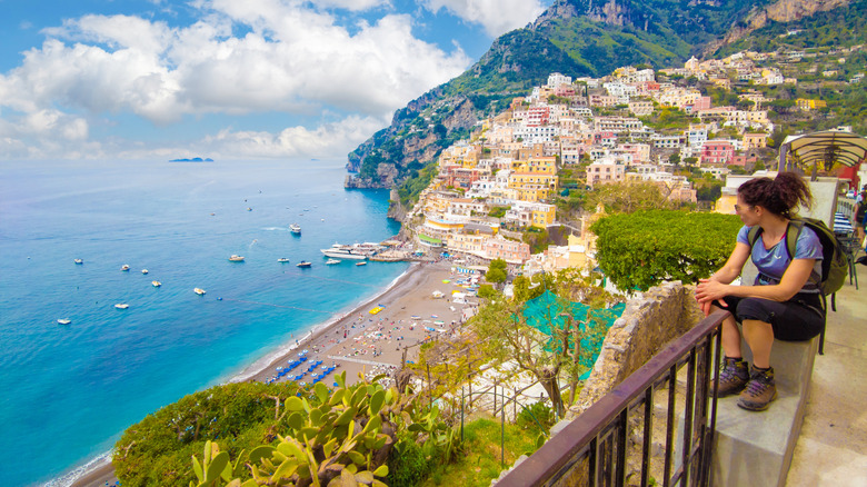 A hiker looking down at Positano from the Path of the Gods on Italy's Amalfi Coast