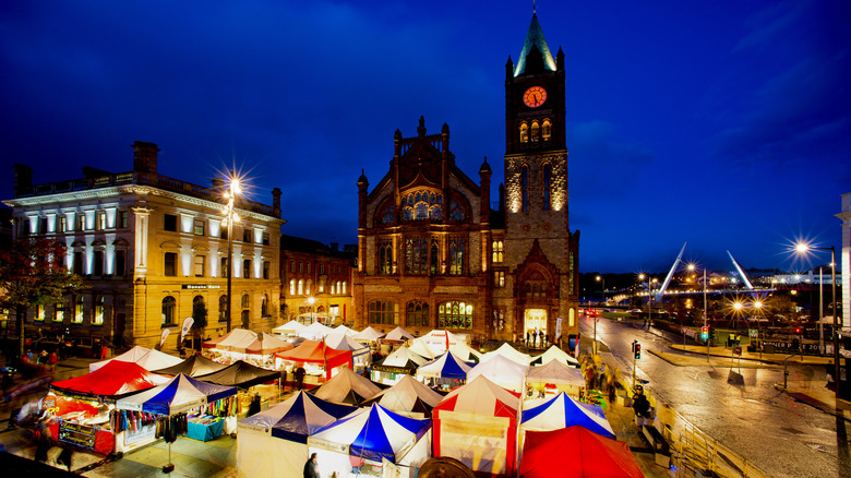 Ireland's Derry Halloween market stalls positioned outside a historic church in the city center