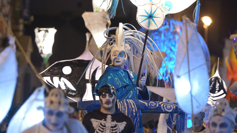 Costumed performers on a blue float during the Derry Halloween parade in Ireland