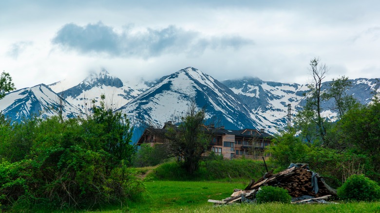 Guesthouses and trees in a valley below the Pirin Mountains near Bansko, Southwestern Bulgaria