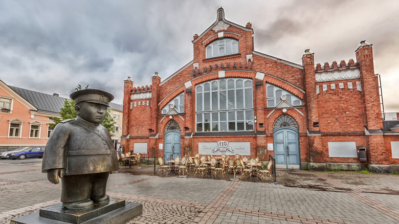 Oulu main square and red brick market hall with policeman statue