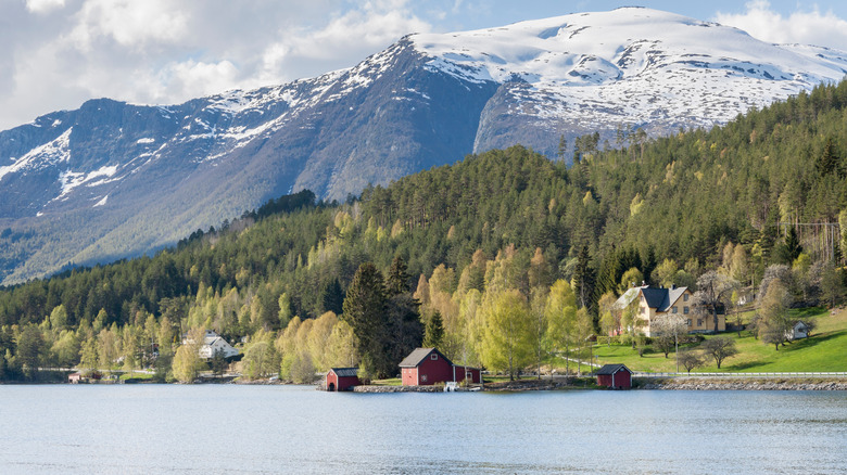 Verdant mountains and snow-capped peaks surrounding Hornindalsvatnet in Norway