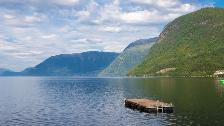 The village of Grodas in Norway, located on Hornindalsvatnet, the deepest lake of Europe, surrounded by green fields and mountains