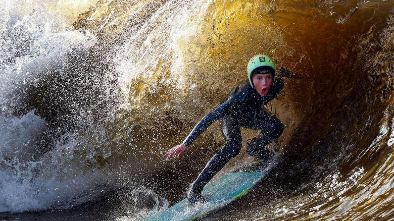 Young boy surfing at the Lost Shore Surf Resort
