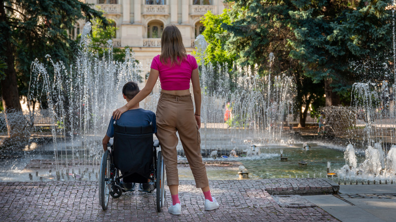 Wheelchair bound tourist and companion in Europe
