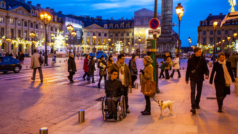 Man in a  wheelchair in city square in Paris, France