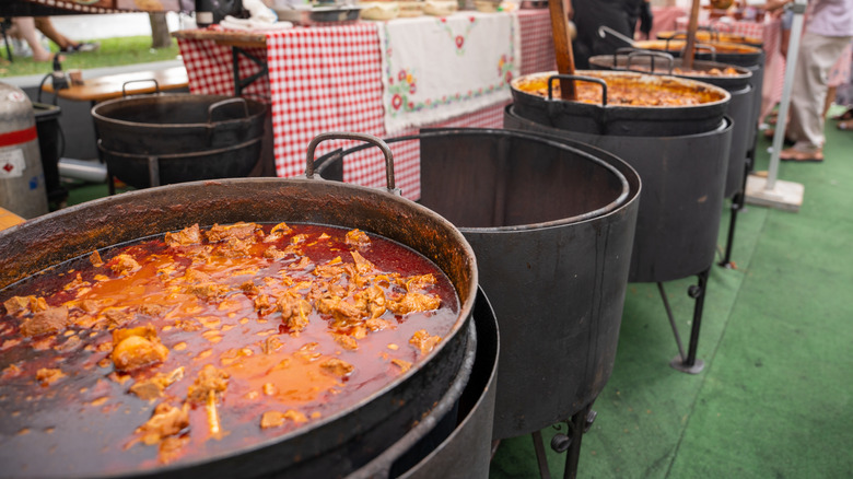 Cauldrons of Hungarian goulash simmer at a street festival in Budapest