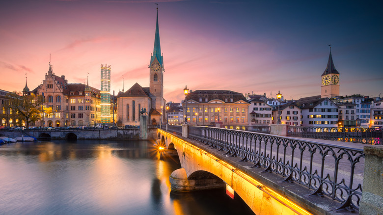 Skyline of a European city with bridge on the foreground at twilight