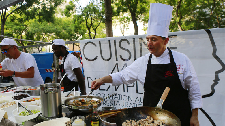 Chefs cooking at an outdoor food festival in France
