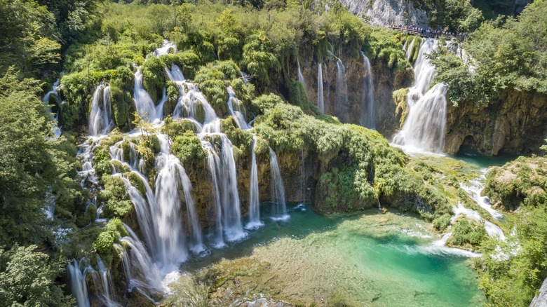 Tourists overlooking the beautiful Waterfalls, Plitvice Lakes National Park, Croatia.