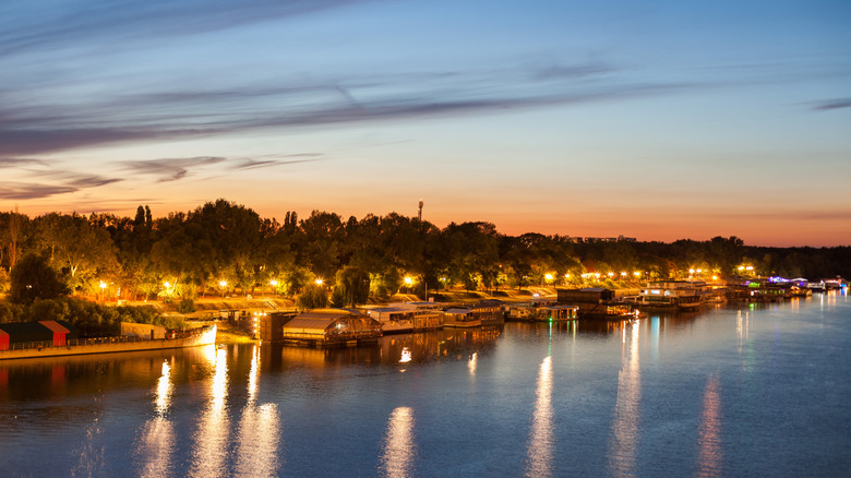 Splav boats lining the banks of the River Sava in Belgrade at sunset