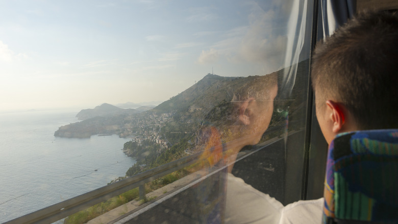 A person looking out the window of a train at the Adriatic Sea in Croatia