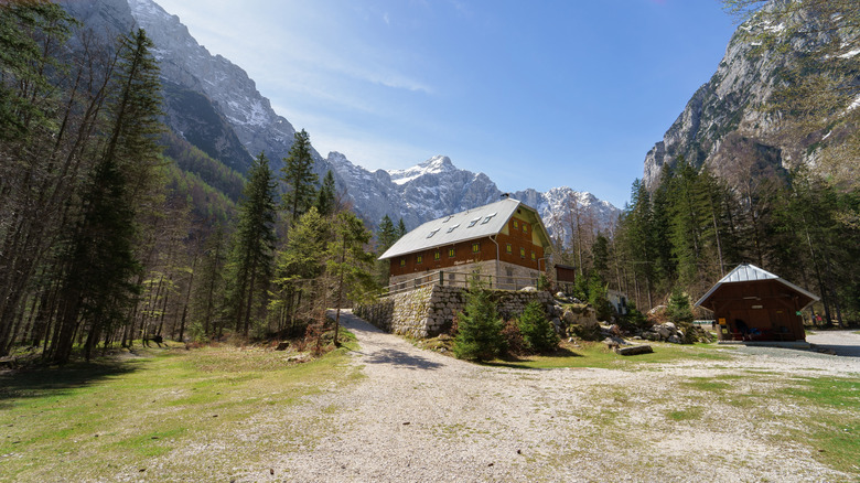 Mountains surrounding cabins in a forest in Triglav National Park, Slovenia
