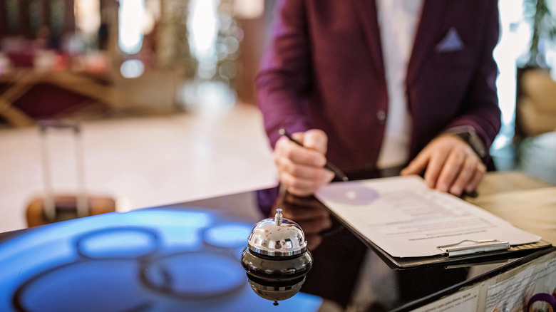a hotel guest looks over their bill