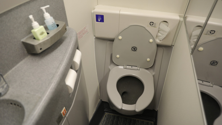 An airplane toilet in a lavatory stall