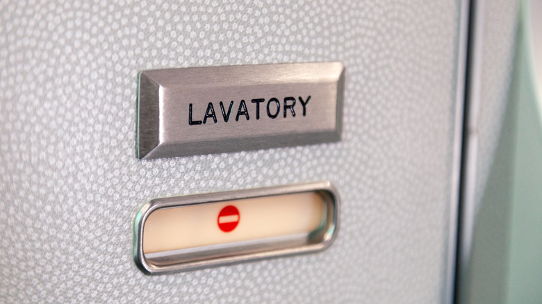 An airplane lavatory sign, marking the stall as occupied