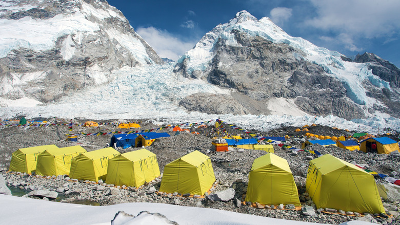 View of yellow tents and snow-capped mountains at Everest Base Camp in Nepal