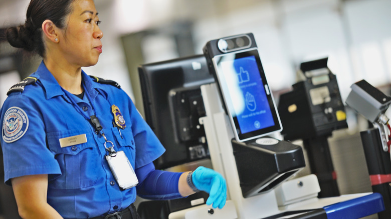TSA Agent with facial scanning Machine
