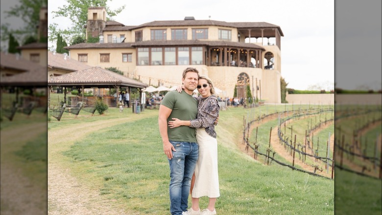 A couple posing in front of Montaluce Winery on summer day.