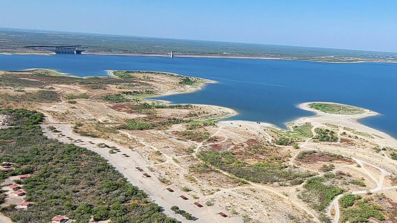 Aerial view of the sandy shore by the water at Falcon State Park in Texas