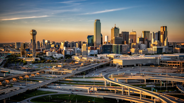 The sun sets over the Dallas skyline, as an aerial viewed from the suburbs