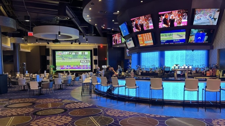 A bar, TVs, and seating inside the Finger Lakes Gaming and Racetrack