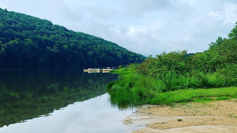 Boats float near sandy beach of Laurel Hill Lake, Tennessee