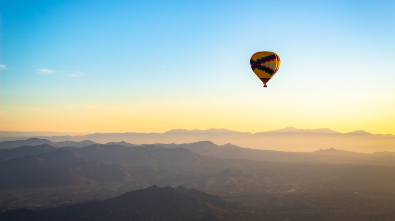 Hot-air balloon flies over Sedona at sunrise