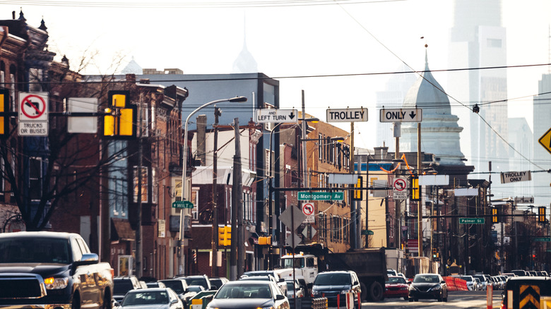A busy street scene in Fishtown, Philadelphia, with downtown in the background