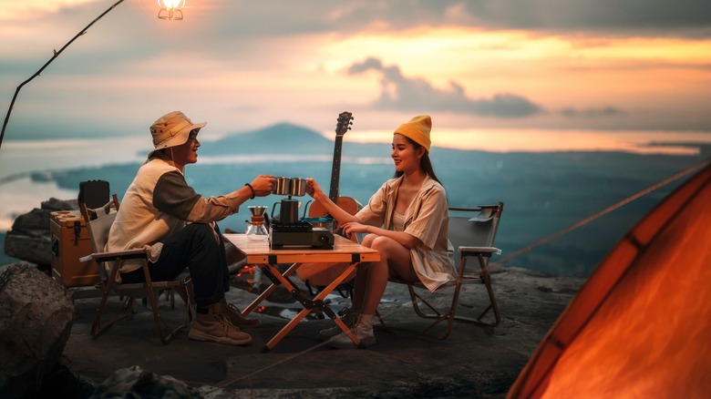 A group of people surrounding a campfire.