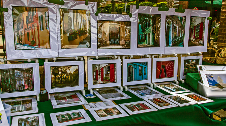 Framed pictures of Charleston landmarks on stall at City Market
