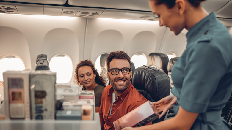 Flight attendant serves passenger