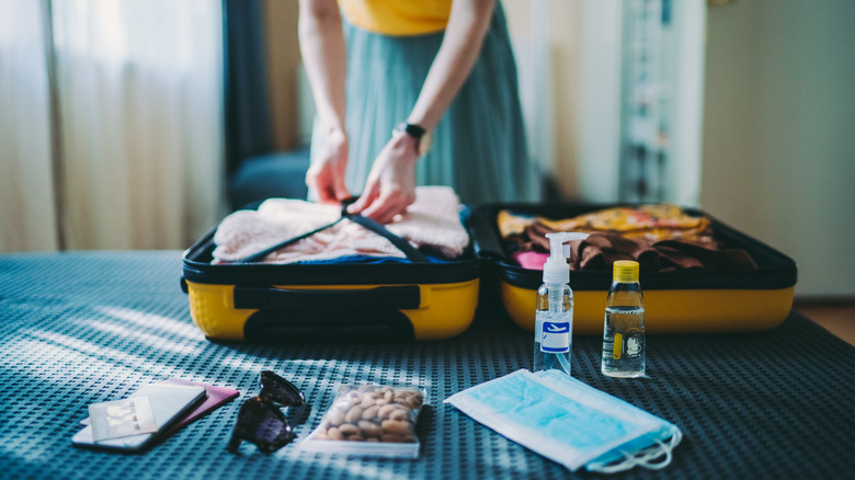 woman packing a small suitcase