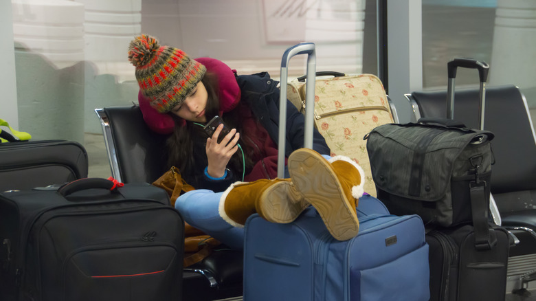 Woman wearing bulky clothes airport