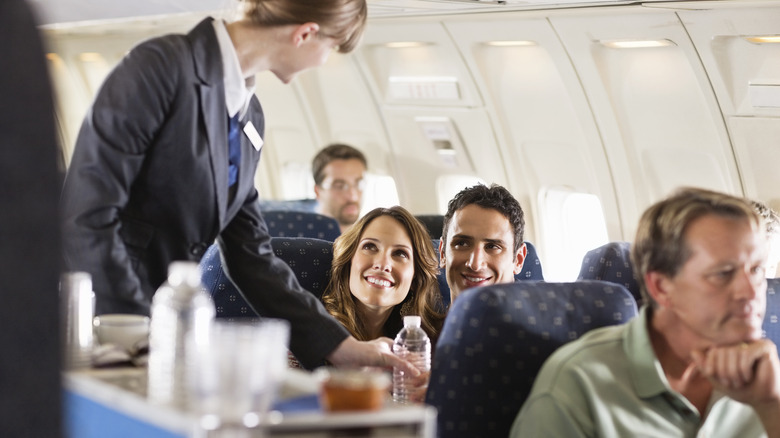 A couple talking to a flight attendant