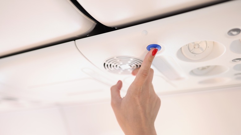 A passenger pressing the call button
