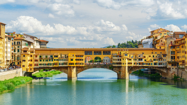The Ponte Vecchio stretching over the Arno River on a sunny day