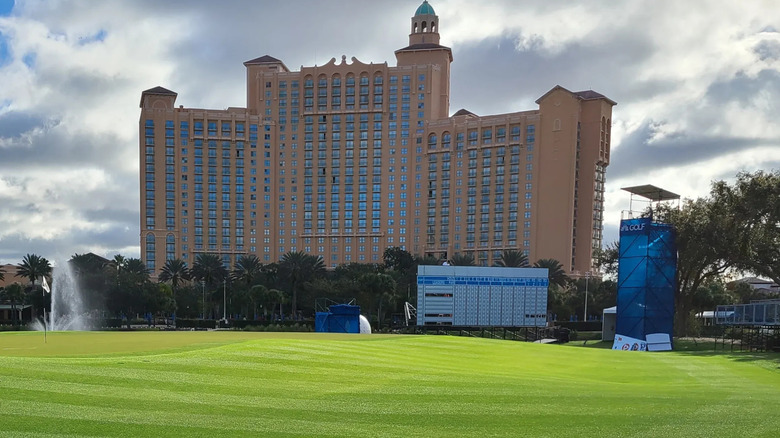 golf course with building in background at the Ritz Carlton Orlando Grande Lakes